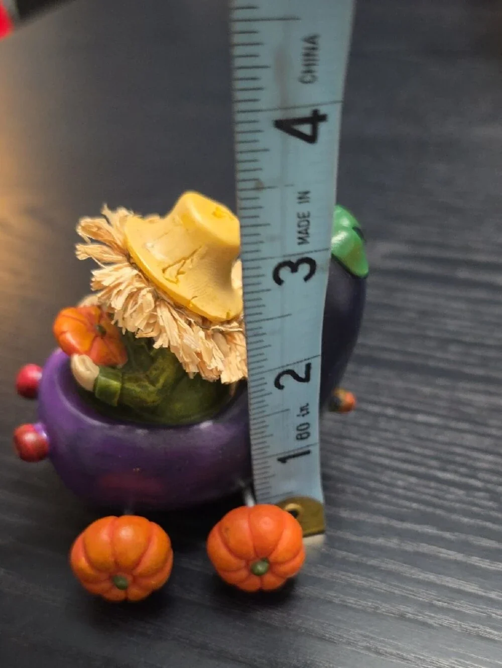 Autumn figurine of a scarecrow in a Eggplant cart